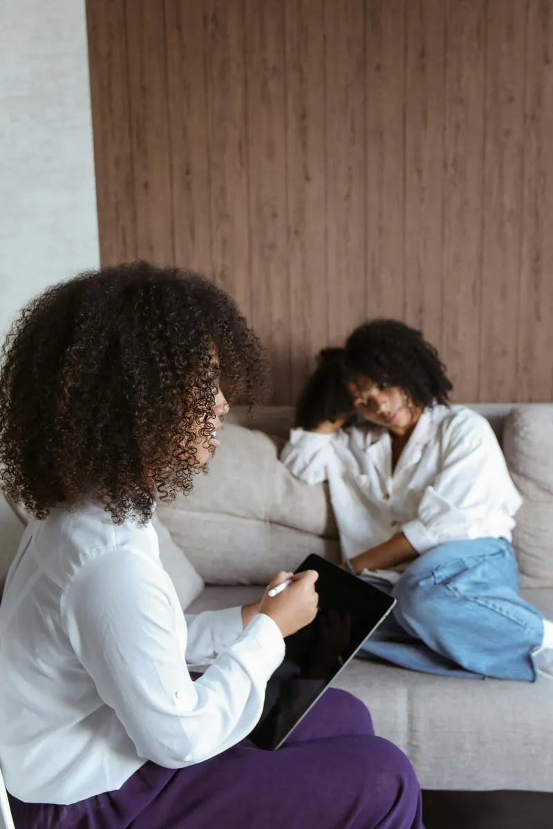 A pastoral counselor in a warm, dignified conversation with a client, Christian counseling in Cincinnati